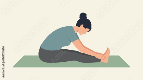 Woman sitting on green mat stretching legs in yoga pose indoors