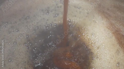 Hot soy sauce broth poured into pot