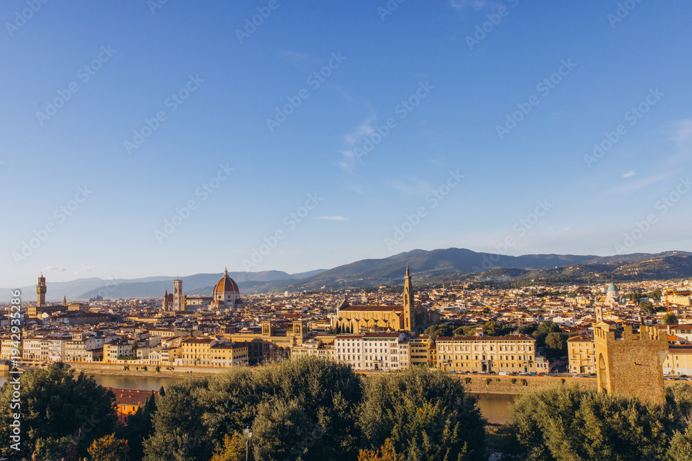 Obraz premium Florence skyline panoramic view with Duomo and historic buildings along Arno river under blue sky