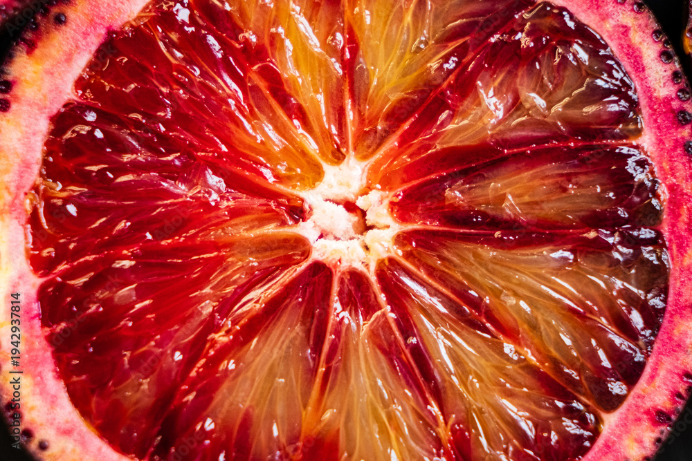 Obraz premium Vibrant display of a blood orange revealing juicy, sun-kissed segments and rich colors