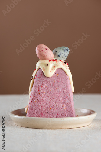 Paskha vegan cottage cheese, Easter dessert made with almond ricotta, strawberries, icing and marzipan eggs in a plate.