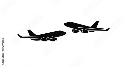 Two commercial airplanes in flight depicted as a striking silhouette