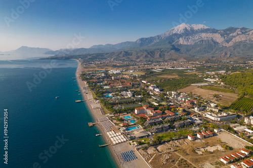 Aerial drone view of Mediterranean coastline with beach resorts and Taurus Mountains in Kemer Turkey