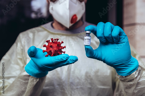 Healthcare worker holding model of Corona Virus and vaccine