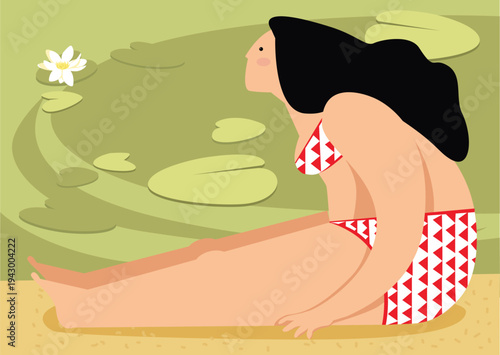 A woman looks at a lotus while sitting by the water