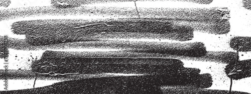 Horizontal black spray paint strokes on a gritty, textured white surface