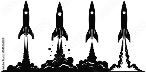 Four rockets launching into space with smoke trails