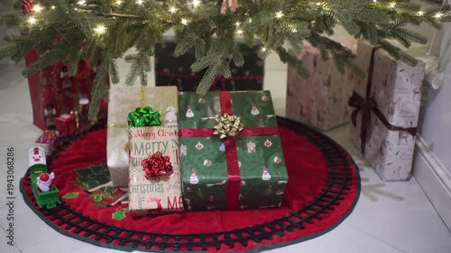 Toy Train With Santa Claus On A Round Railway In Front Of A Christmas Tree.