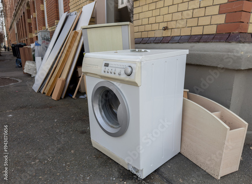 old washing machine bulky waste for recycling on a street in the city