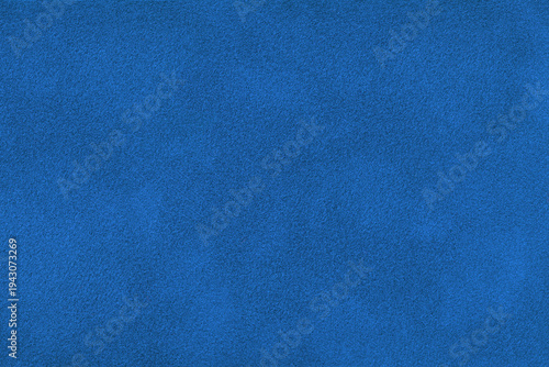 Dark blue suede fabric background with matte nap velvet texture. Royal blue tones and soft felt textile surface in macro