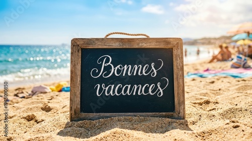 Beach vacation sign with Bonnes Vacances message on sandy shore