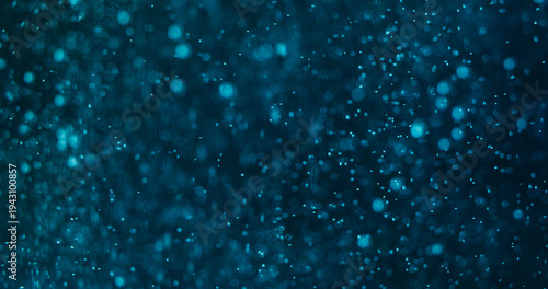 Bokeh circles. Luminosity particles. Blue shimmering stream on black night. Color flying confetti glow abstract defocused background.