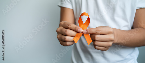 woman with Orange Ribbon for Leukemia, Kidney cancer day, world Multiple Sclerosis, CRPS, Self Injury Awareness month. Healthcare and word cancer day concept