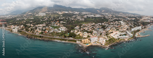 Tableau sur toile Aerial view of Nerja, Costa del Sol, Malaga, with whitewashed villas, terraced r