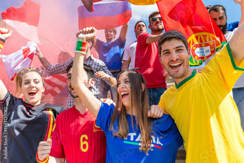 Diverse soccer fans cheering and celebrating with flags