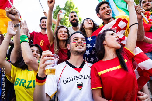 Sports fans supporting team with national flags cheering together