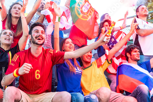 Diverse sports fans cheering passionately in stadium