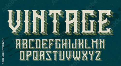 Vintage ornate typography alphabet display on teal background.