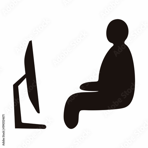 Silhouette of a person sitting in front of a computer screen working
