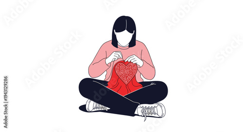Focused young woman sitting cross legged on the floor while doing embroidery work and stitching a decorative red heart design on fabric.