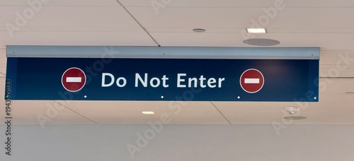 фотографія Do Not Enter sign hanging over a hallway