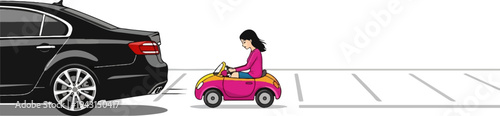 Girl in pink toy car next to a large black car in a parking lot
