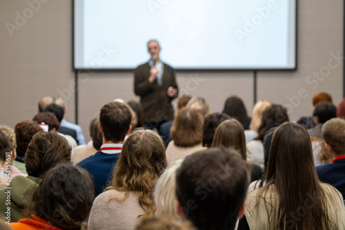 Wallpaper Mural Conference audience listening to speaker during presentation in lecture hall, professional seminar atmosphere, focus, learning, engagement. Torontodigital.ca