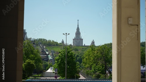View of the main building of Moscow State University from the park in the summer . Dolly camera