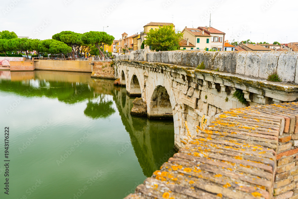 Fototapeta premium Tiberius Bridge over the river in Rimini. Italian classical architecture. A city landmark. Italy old city