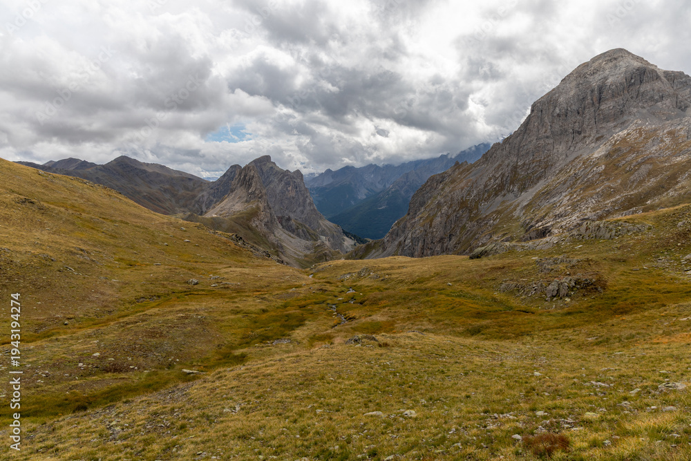 Obraz premium Cerces massif landscape under a moody cloudy sky and high‑altitude atmosphere in the French Alps