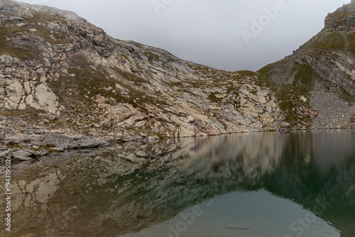 Alpine Lac Blanc in the Cerces massif with dramatic clouds , French Alps