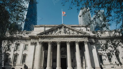 Historic building with modern skyscrapers nearby.