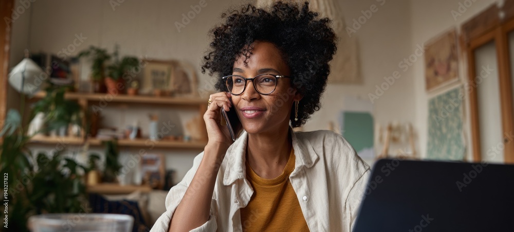 Fototapeta premium Woman using phone at desk