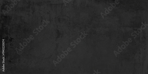 Dark grunge background with copy space featuring a textured black stone wall and vintage gray concrete surface for a rough blank backdrop design