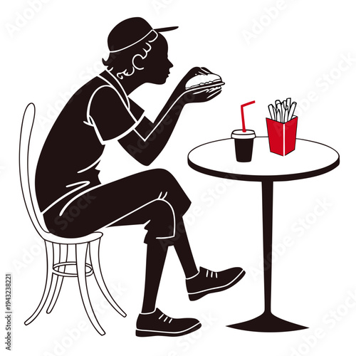 Person wearing cap and casual attire sitting at a table eating a hamburger with fries and a drink, fast food dining scene