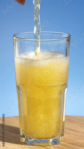 Healthy, flavored fresh sparkling kombucha poured into a glass. Iced fizzy drinks, and summer vibes.