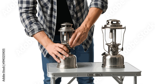Man assembling camping lantern on portable table outdoors