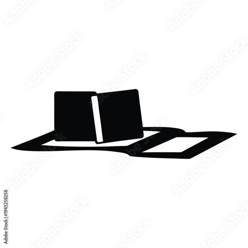 A Silhouette of an Open Book Lying Flat on a Surface