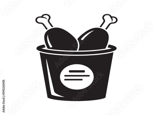 Black and white bucket of fried chicken drumsticks with bones