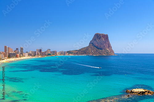 Calpe town coastline aerial view Costa Blanca coast with Penyal d'Ifac Natural Park rock mountain, sandy beach, Bahia de Calpe bay Mediterranean Sea with azure water in sunny summer day, Spain
