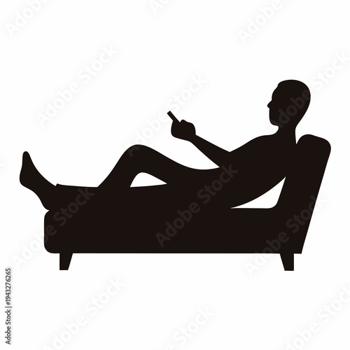 Silhouette of a person lying on a sofa using a cell phone
