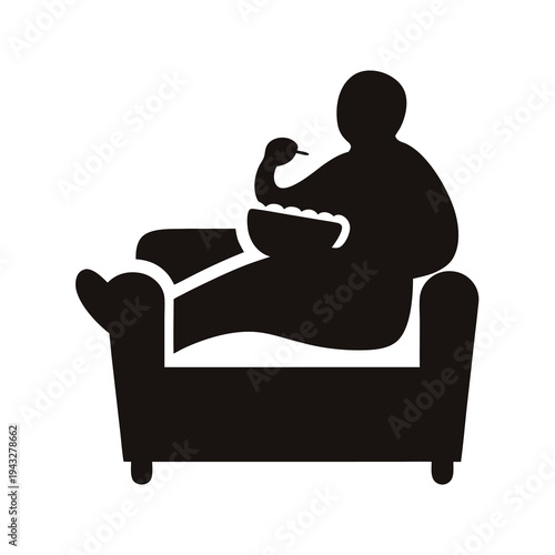 Silhouette of an individual reclining on a couch and eating snacks