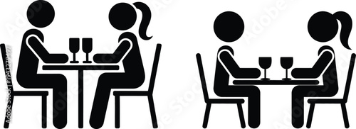 A couple sitting at a table with two glasses