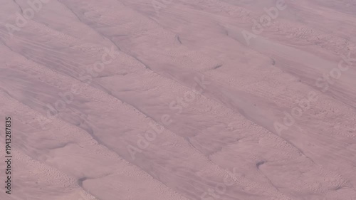overflying Sharqiya Sands (Wahiba Sands), a Oman desert with wavy surface and reddish sand, located in Dschanub asch-Scharqiyya Government of Oman - 4k aerial video footage 