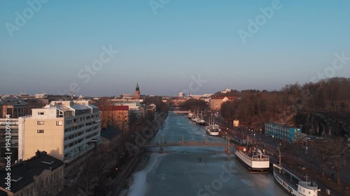 Aerial panorama of Turku city and frozen Aura River at spring sunset