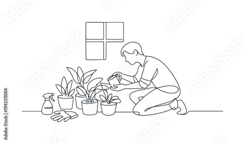 Person kneeling beside several potted houseplants watering leaves with a small watering can, spray bottle and gardening gloves