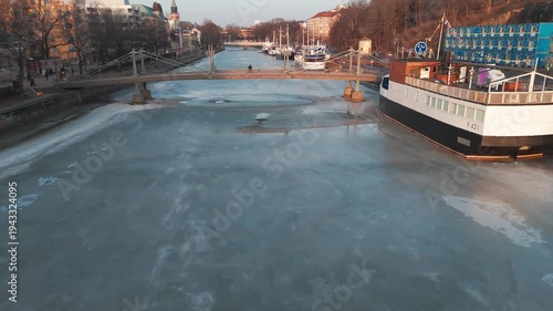 Aerial panorama of Turku city and frozen Aura River at spring sunset