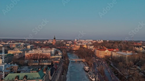 Aerial panorama of Turku city and frozen Aura River at spring sunset