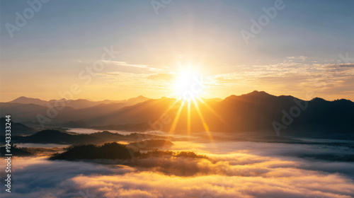 Rising golden sun shining over mountain peaks and fluffy clouds creating a serene and breathtaking morning landscape