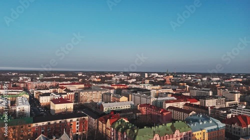 Aerial flyover rooftops towards the Turku Cathedral (Turun tuomiokirkko), Finland.